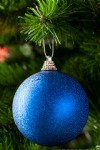 Blue Christmas Bauble on a Pine Tree