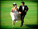 Wedding Couple running in a Green Field